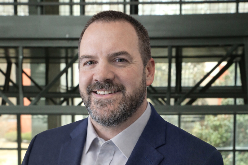 recruiter Darrell Simpson in front of an industrial background.